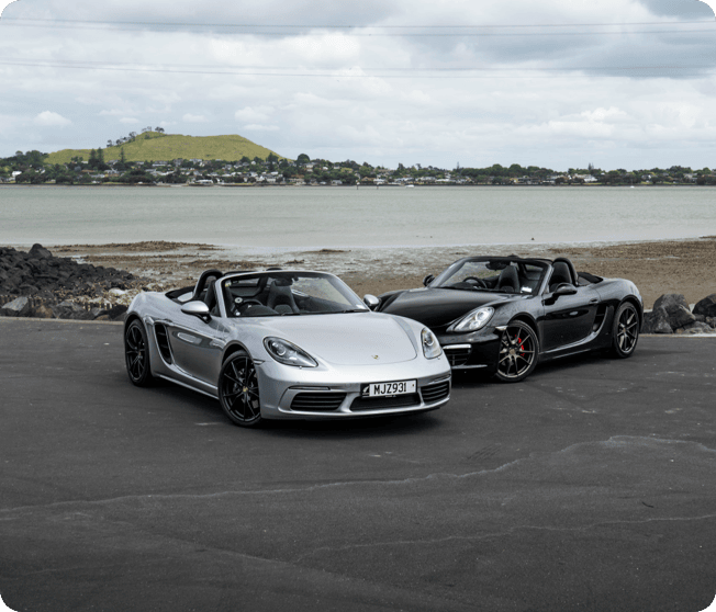 Luxury cars on a scenic coastal drive